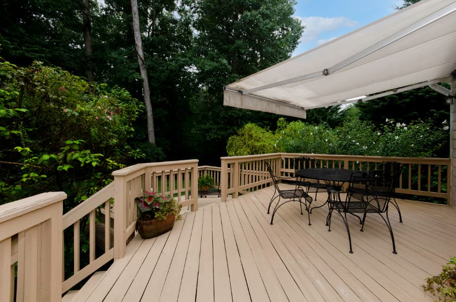 Wooden deck with awning and furniture