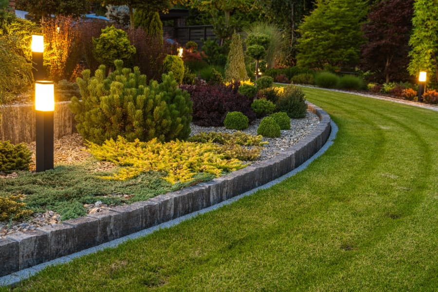 Professionally landscaped backyard with lamps